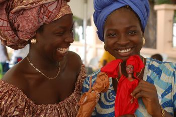 Ghanaian women holding dolls